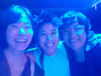 3 persons smiling into the camera in ble light